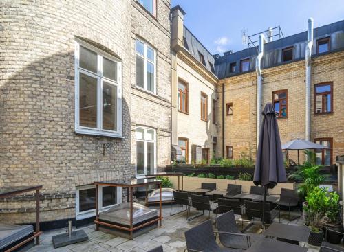 an outdoor patio with a table and an umbrella at TwentySix in Malmö