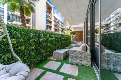 an outdoor patio with chairs and plants on a building at FAM Living - City Walk - Opulent Living in Dubai