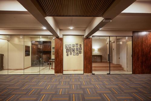 a lobby with glass doors and a room with stairs at Firebrick Boutique Residences - AMETHYST HOUSE in Gurgaon