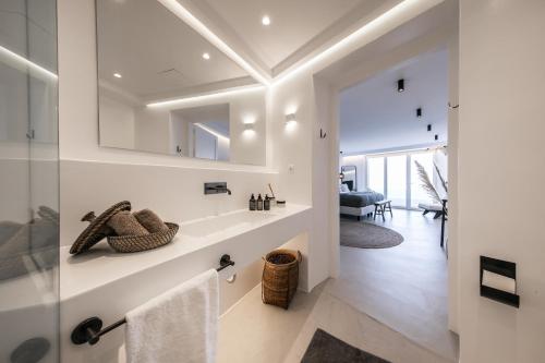 a bathroom with a sink and a mirror at Villa Joy Mykonos Boutique Hotel in Ano Mera
