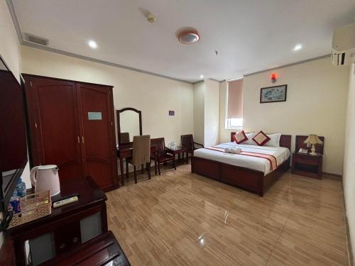 a hotel room with a bed and a dining room at Asia Hotel Can Tho in Can Tho