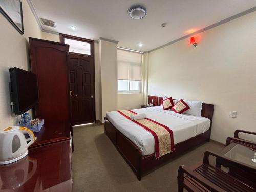 a hotel room with a bed and a television at Asia Hotel Can Tho in Can Tho