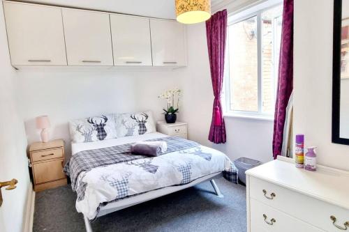 a bedroom with a bed and a window at 1 bedroom flat in thurmaston in Thurcaston