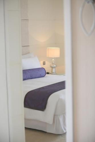 a bedroom with a bed and a lamp on a table at Dorsett Shanghai in Shanghai