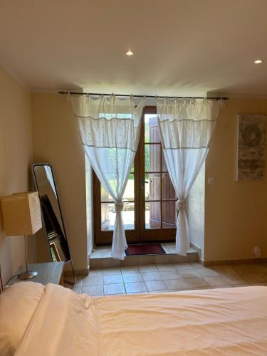 a bedroom with a bed and a window with curtains at Spacious Farmhouse Apartment, by Lake & Mountains in Larringes
