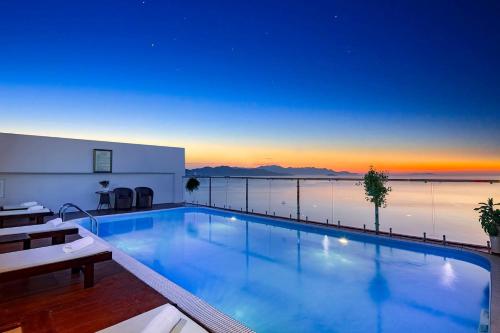 a large swimming pool with a view of the water at Paris Luxury Hotel & Apartment Nha Trang in Nha Trang