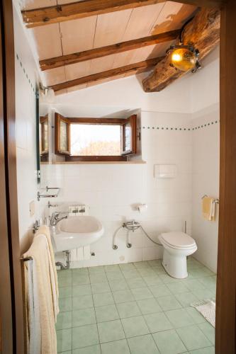 a bathroom with a sink and a toilet at Poggio Al Vento in Castiglione dʼOrcia