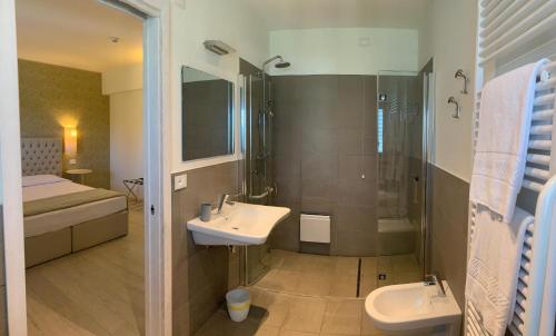 a bathroom with a sink and a shower at Nuova Opera Rooms in Verona