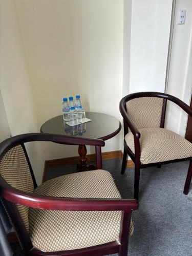 two chairs and a table with water bottles on it at Asia Hotel Can Tho in Can Tho