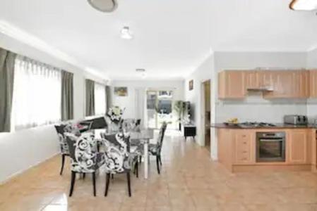a kitchen and dining room with a table and chairs at Bexley North Entire 2 Storey House 4 or 5 BR 11 Beds 5 mns walk to Train Station and Close to Airport , Sydney CBD in Sydney