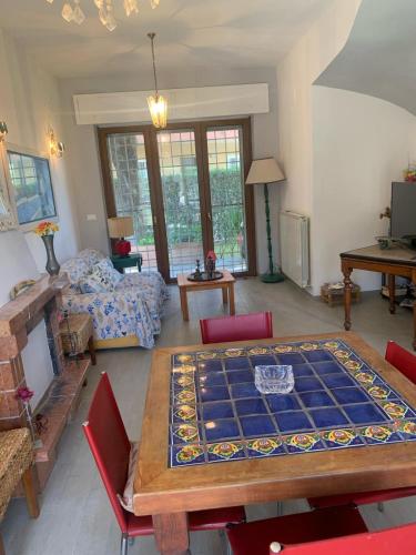 a living room with a table with a large tiles on it at La Nave di Stefy in Fregene
