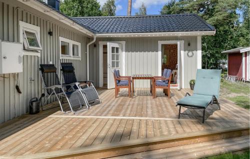 a wooden deck with a table and chairs on it at 3 Bedroom Cozy Home In Jönköping in Jönköping