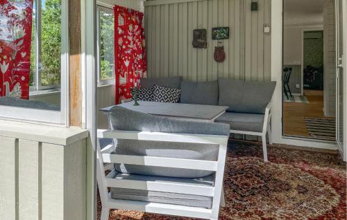 a living room with a couch and a table at 3 Bedroom Cozy Home In Jönköping in Jönköping