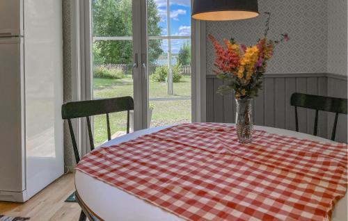 a table with a vase of flowers on top of it at 3 Bedroom Cozy Home In Jönköping in Jönköping
