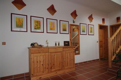 a room with a staircase and some pictures on the wall at Ökopension Villa Weissig in Struppen