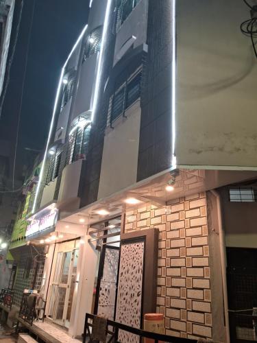 a building with lights on the side of it at night at Hotel Ruby in Ujjain