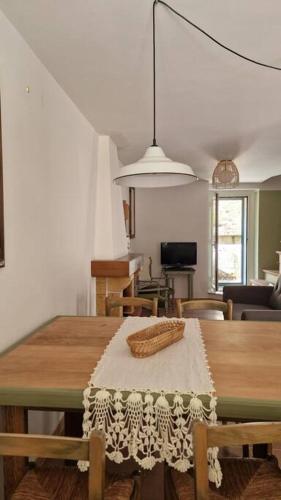 a dining room with a wooden table with a white table cloth at Le case di Papà Nuccio in Pietrabbondante
