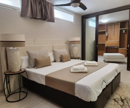 a bedroom with a large bed with white sheets and pillows at MD Malva Valterna in Paterna