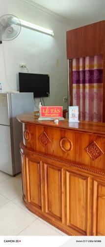 a kitchen with a wooden counter top with a television at Night Market Heart Hotel MC in Mộc Châu