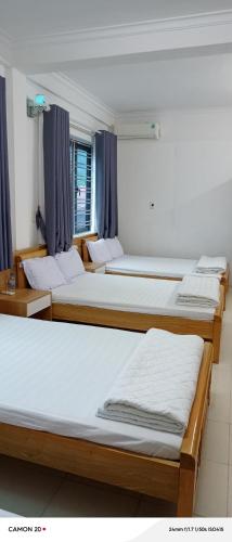 a group of four beds in a room at Night Market Heart Hotel MC in Mộc Châu