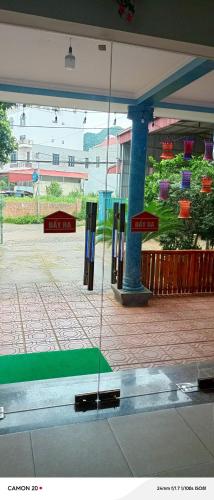 a reflection of a street in a window of a building at Night Market Heart Hotel MC in Mộc Châu