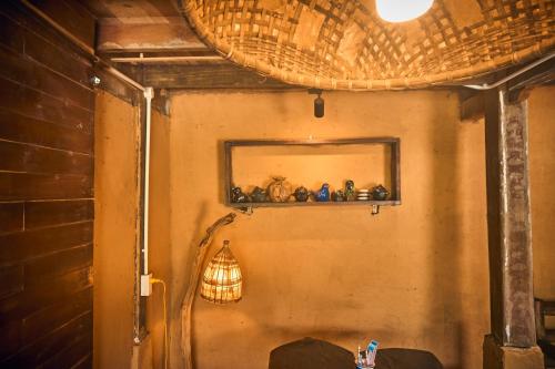 a room with a wall with a shelf and a light at Sa Moc - La Maison House & Bungalow in Sa Pa