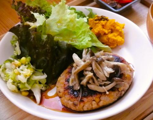 a white plate of food with meat and vegetables at Ten to Sen Guesthouse in Takamatsu