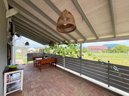a patio with a picnic table and a basket at Dandelion Vendégházak in Kisapáti