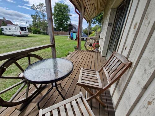 a patio with a table and chairs on a porch at Piibelehe Guest Accommodation in Kuressaare