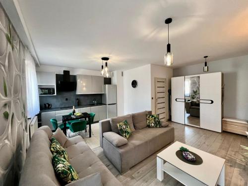 a living room with a couch and a table at Apartament Eva 2 in Jelenia Góra