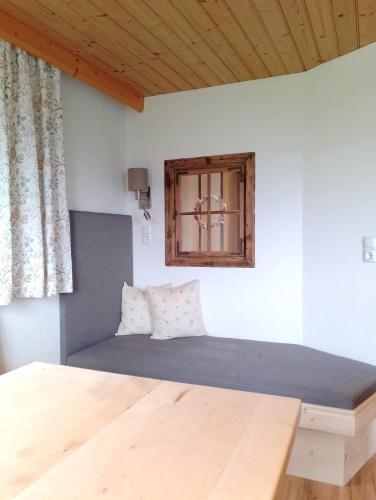 a bed in a room with a window at Stockachhof in Fügenberg