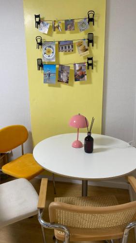 a table with a pink lamp on top of it at Haekong's House in Seoul