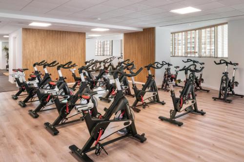 a gym with a bunch of exercise bikes in a room at Melia Valencia in Valencia