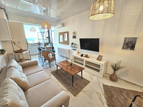 a living room with a couch and a tv at Marianne, Apartament 2 Camere, Stefan Lake 2, Mamaia Nord in Năvodari