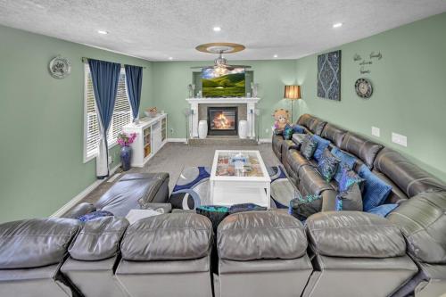 a living room with a large couch and a fireplace at 48a Luxury Lake Home W Massage Meditation Gym Ac in Calgary