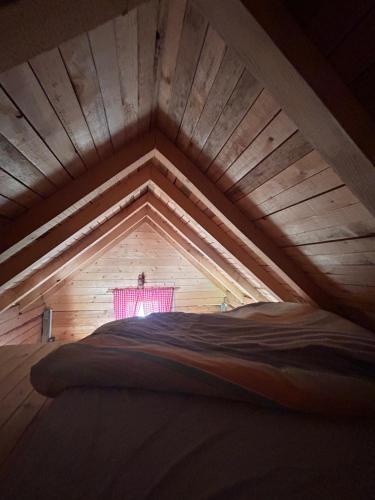 a large wooden attic room with a window in it at ABBA Ethno House in Gusinje