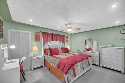 a bedroom with a bed and a dresser and a mirror at 48a Luxury Lake Home W Massage Meditation Gym Ac in Calgary