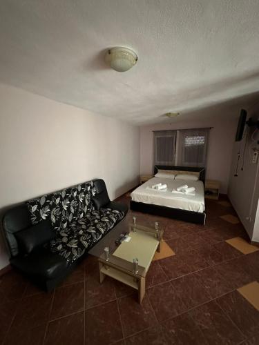 a living room with a bed and a couch at Stellax Apartment in Donji Štoj