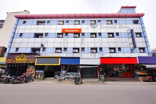a building with motorcycles parked in front of it at FabExpress Le Royal Inn in Chennai