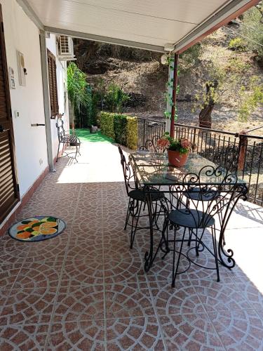 a patio with a table and chairs on a patio at La Pace in Savoca 