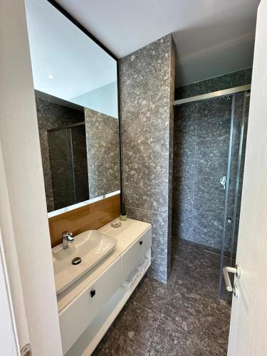 a bathroom with a sink and a mirror at Dukes Albania in Vlorë