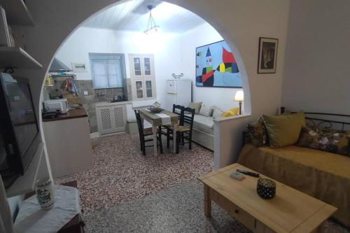 a living room with a couch and a table at Chrisi's and Jasmin's house in Patmos