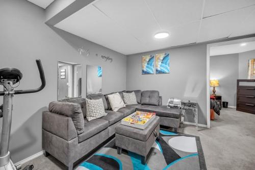 a living room with a couch and a table at 12 Spacious Home W Ac, Crib, Garage, By Airport in Calgary