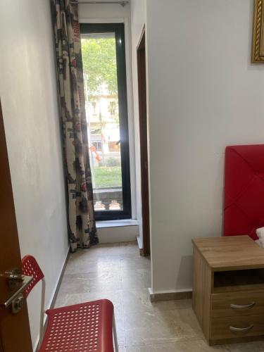 a room with a red chair and a window at Hostal Granvia 628 in Barcelona