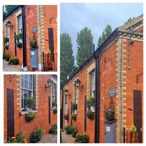 a brick building with a door and flowers on it at The Old Chapel Stoke Bruerne in Towcester