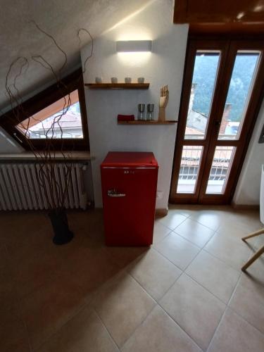 a red refrigerator in a room with windows at Vinadio Sole & Relax in Vinadio