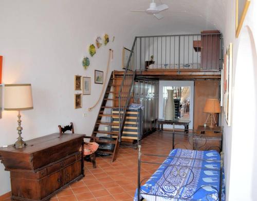 a living room with a loft bed and a staircase at Elegante alloggio Da Zia Flá in Portovenere