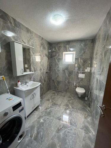 a bathroom with a sink and a toilet at Big City House in Bihać
