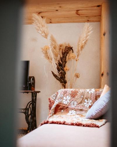 a bedroom with a bed with a pillow and a vase at Thomashof Klein-Mutz in Zehdenick