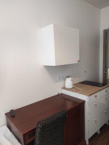 a kitchen with a desk and a white cabinet at Gotthard Residents in Tallinn